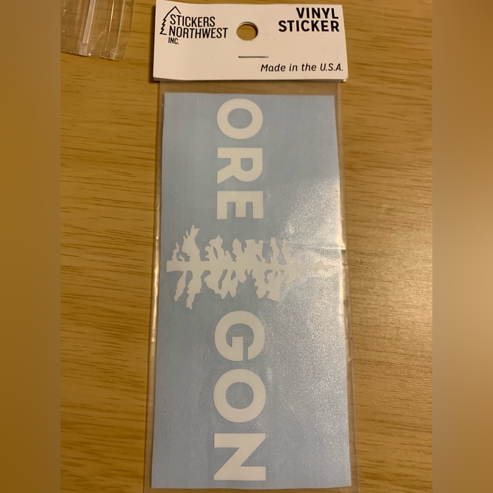 Brand new sticker of OREGON white capital lettering with pine tree